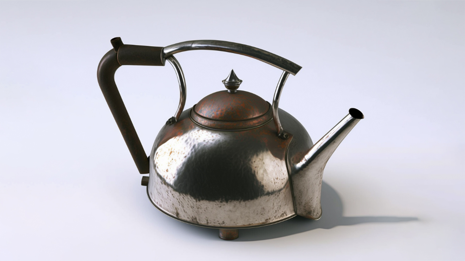 Tarnished silver teapot with three pronged handle