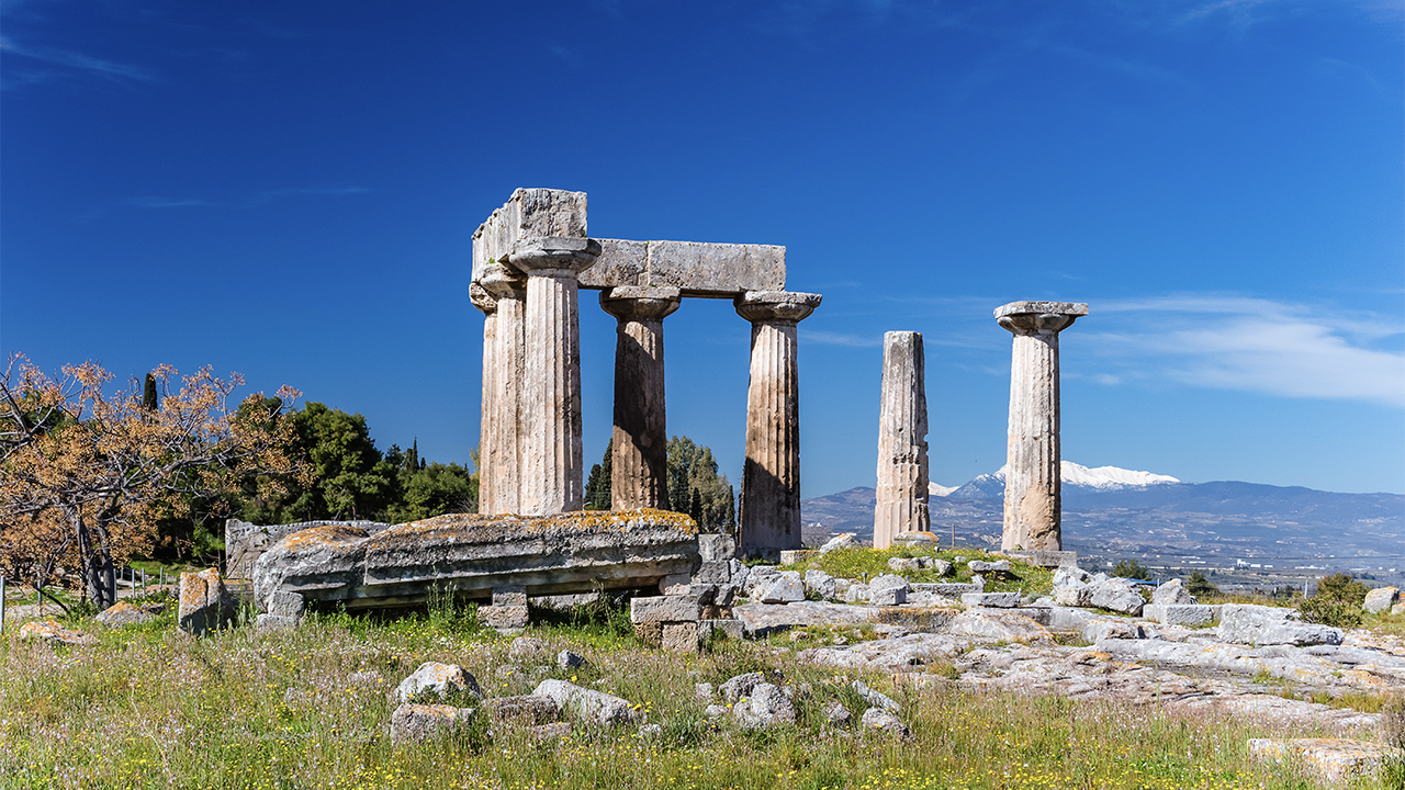 Grey concrete pillars on green grass field under blue sky during daytime