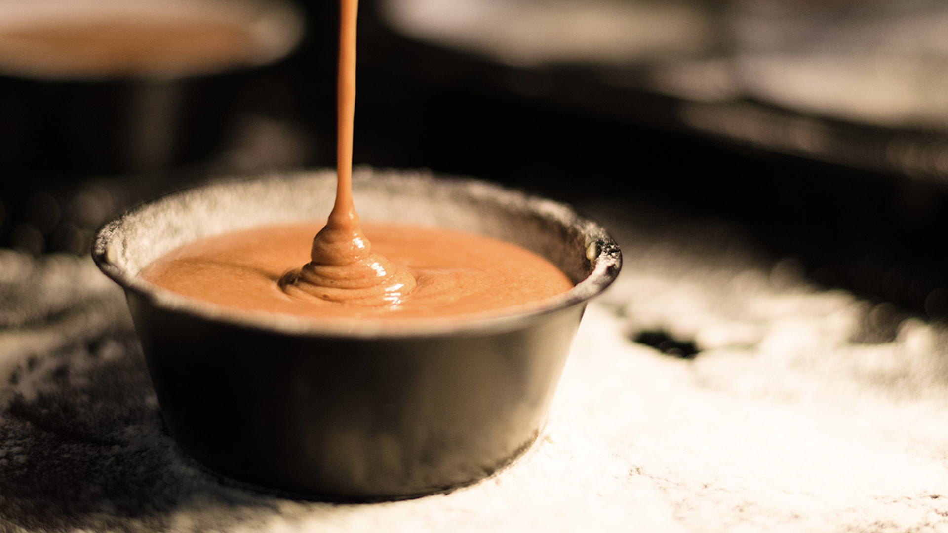 Hot sauce being poured into a cup