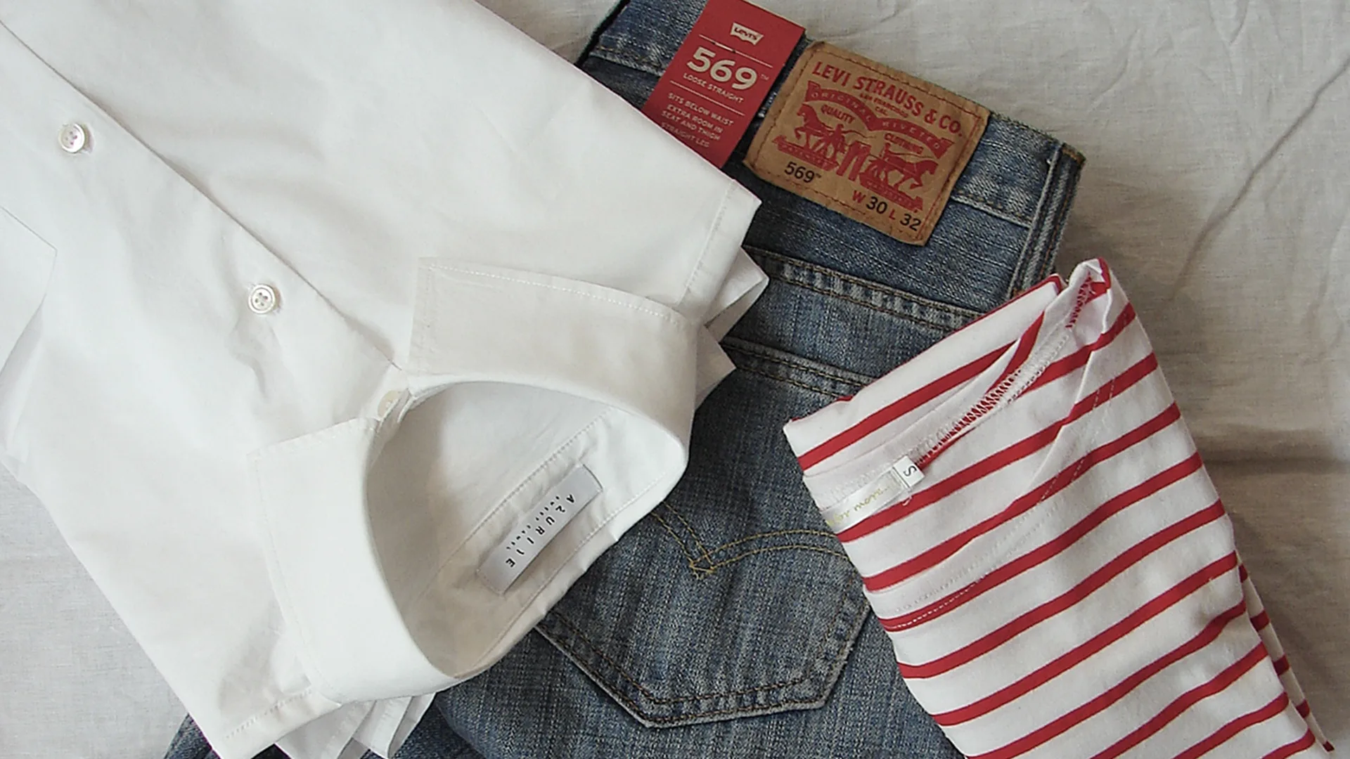 An outfit arranged on a bed