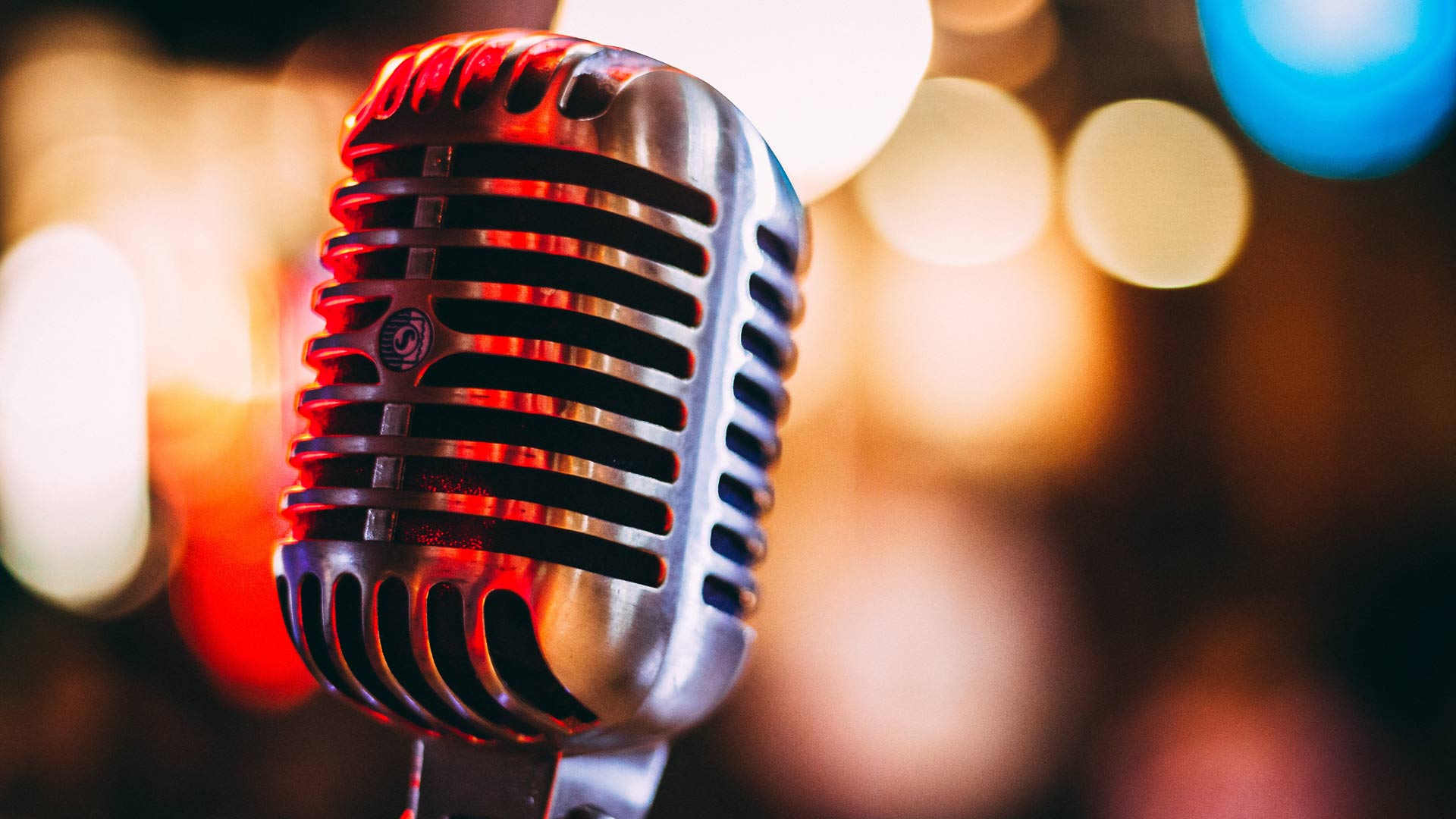 A condenser microphone with bright lights behind it