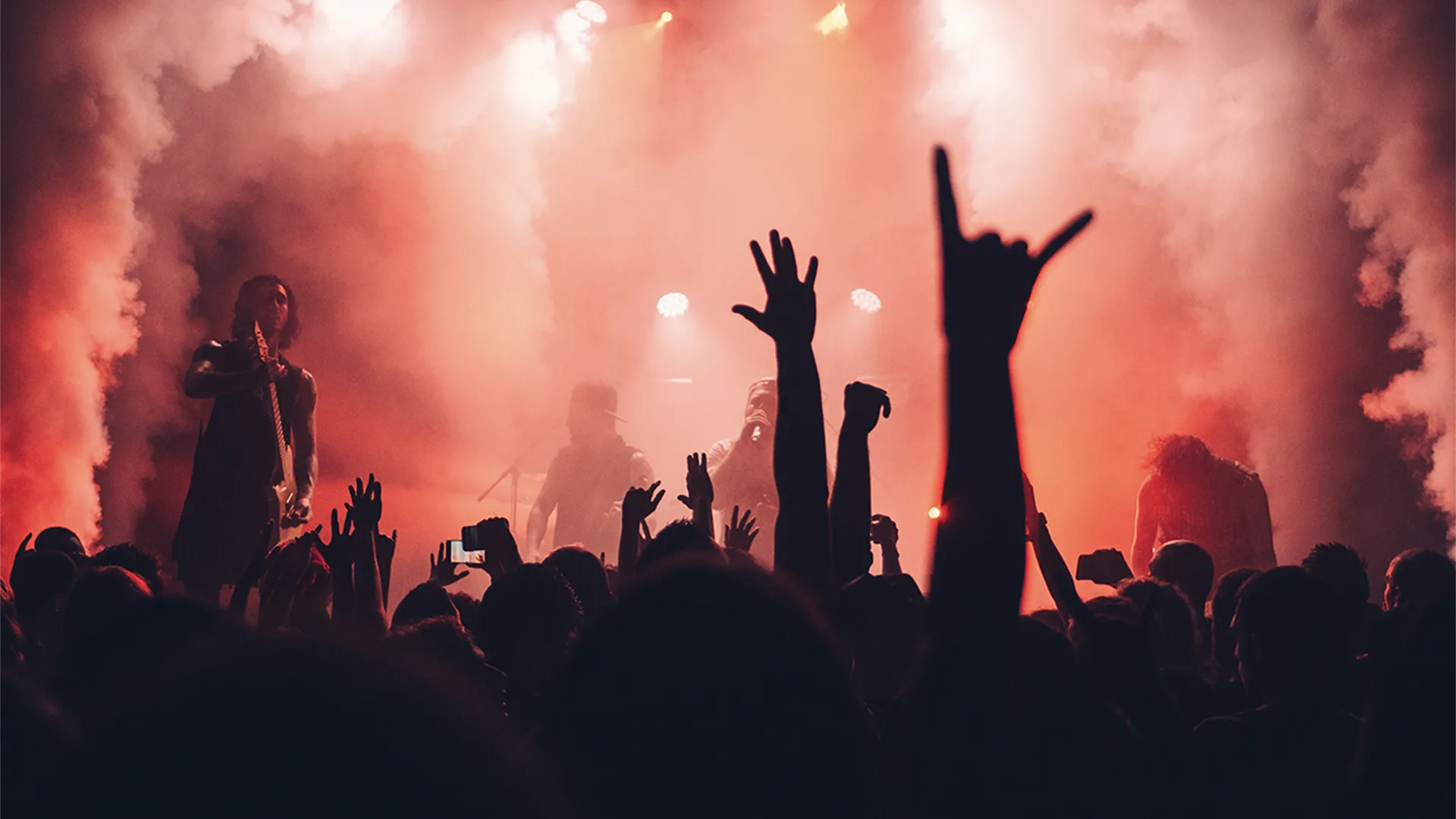 View from crowd of rock band on stage