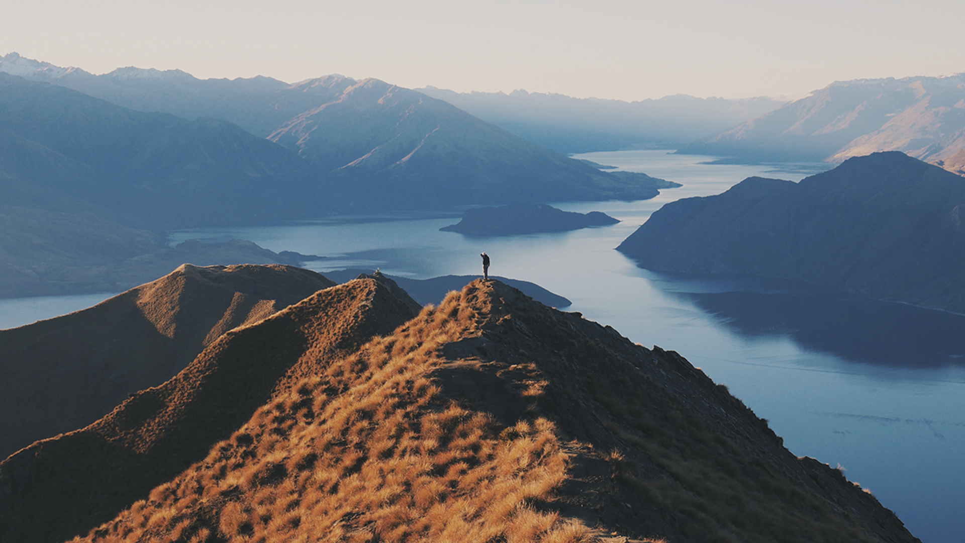 Person standing on top of a hill