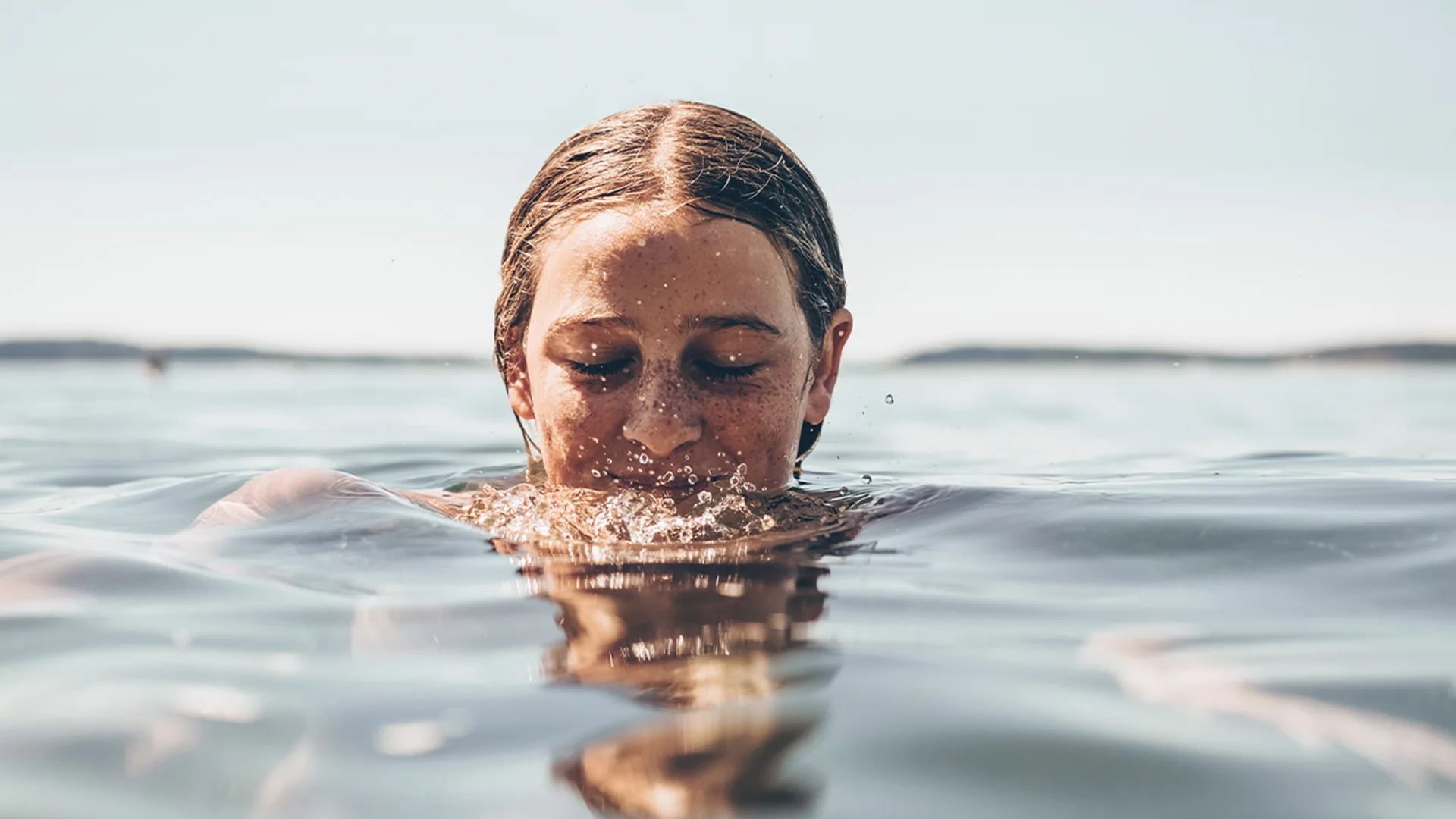Woman swimming in the ocean