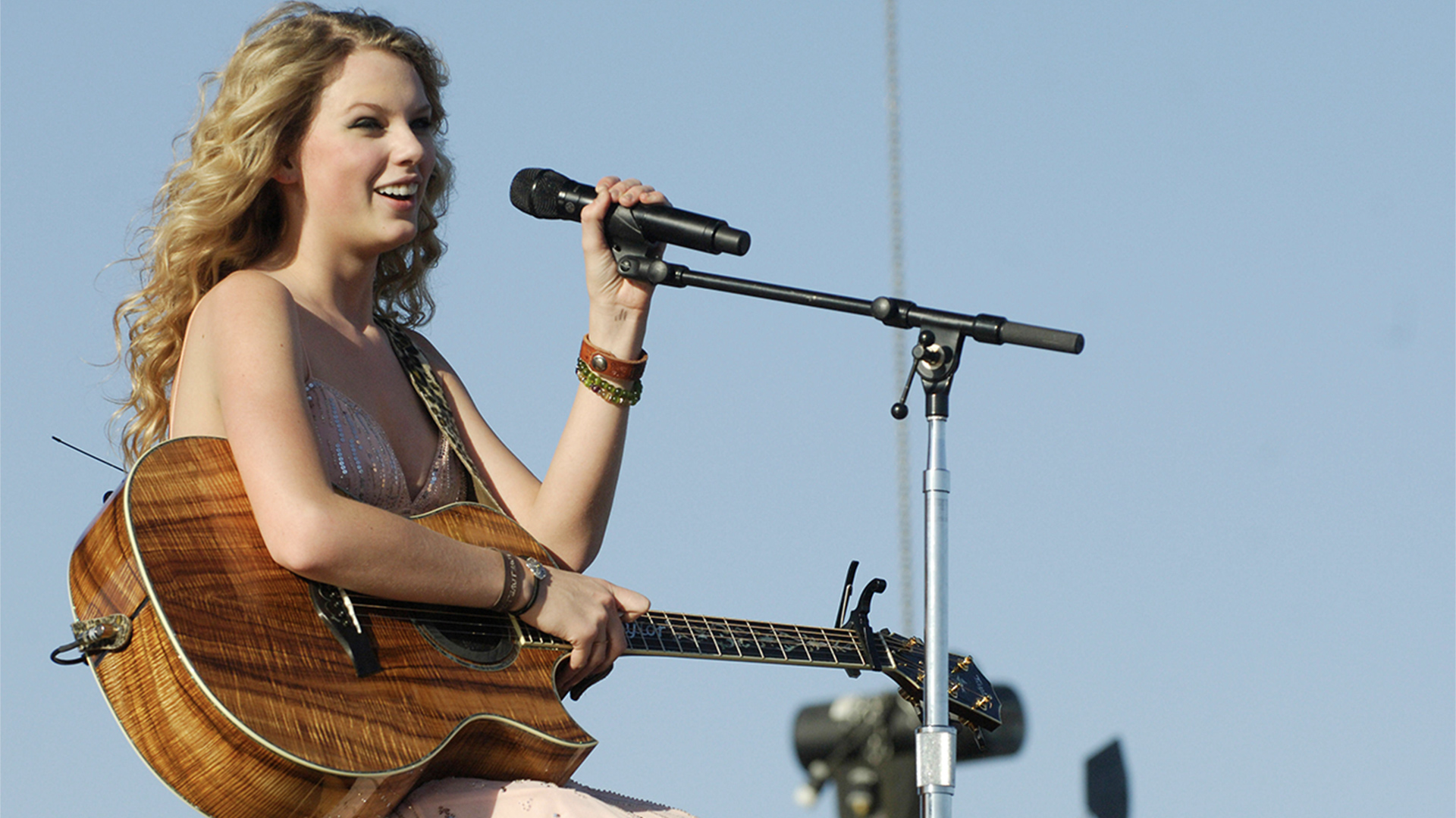 Taylor Swift performing with a guitar
