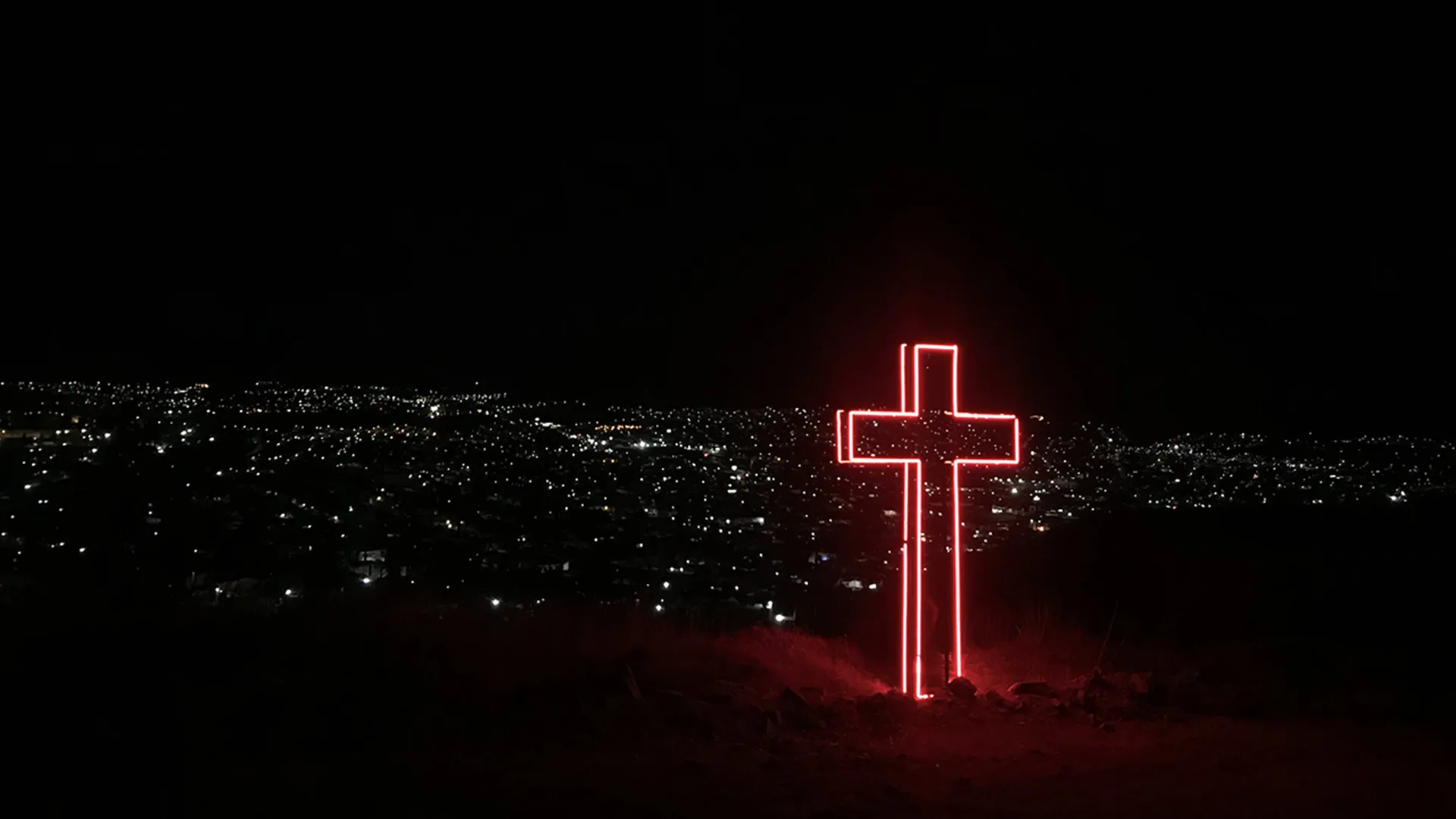 A red neon cross