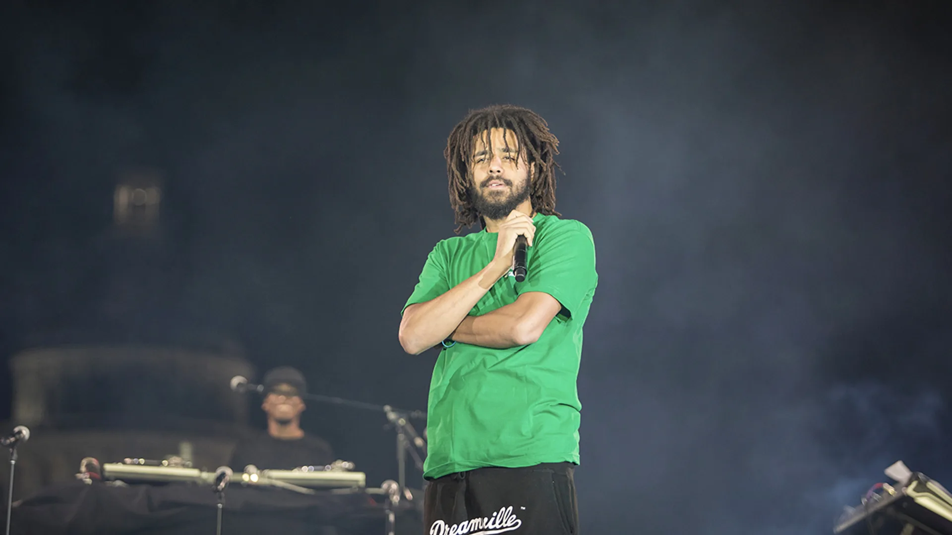 J. Cole performing on stage