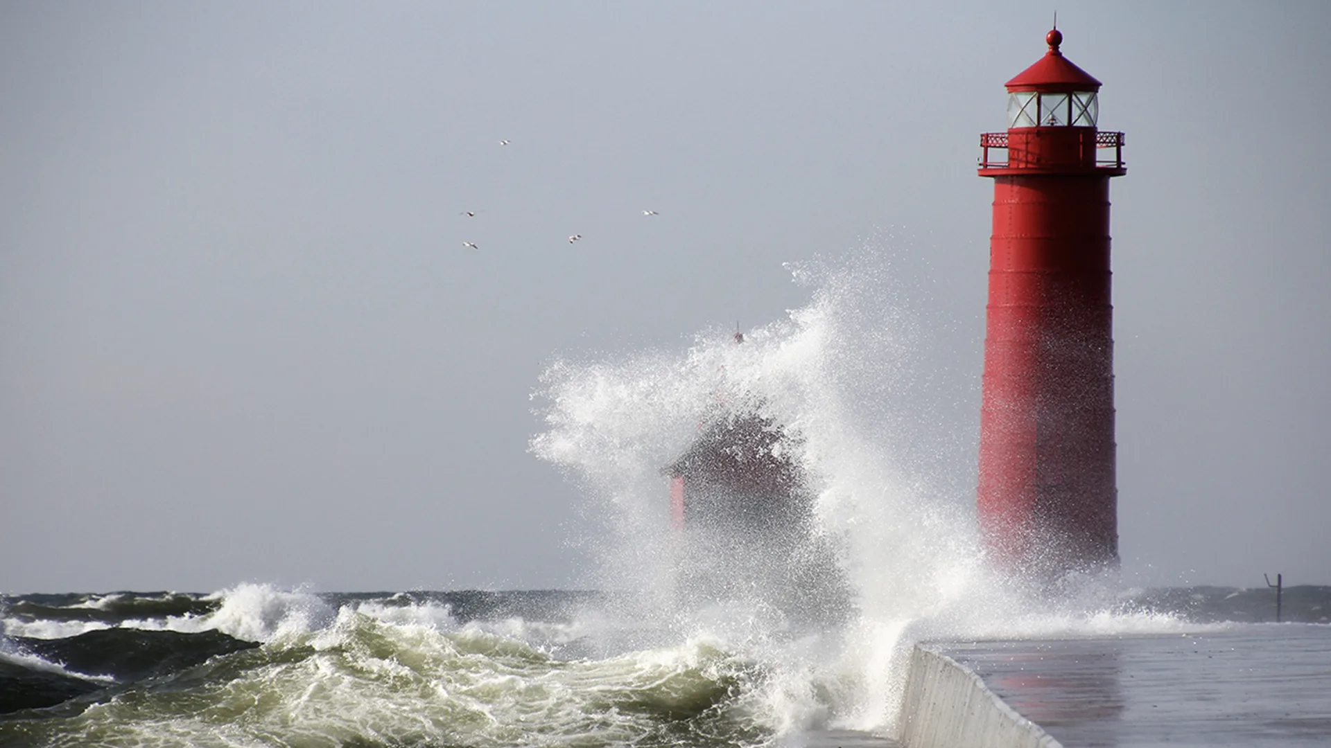 Waves crashing near a lighthouse