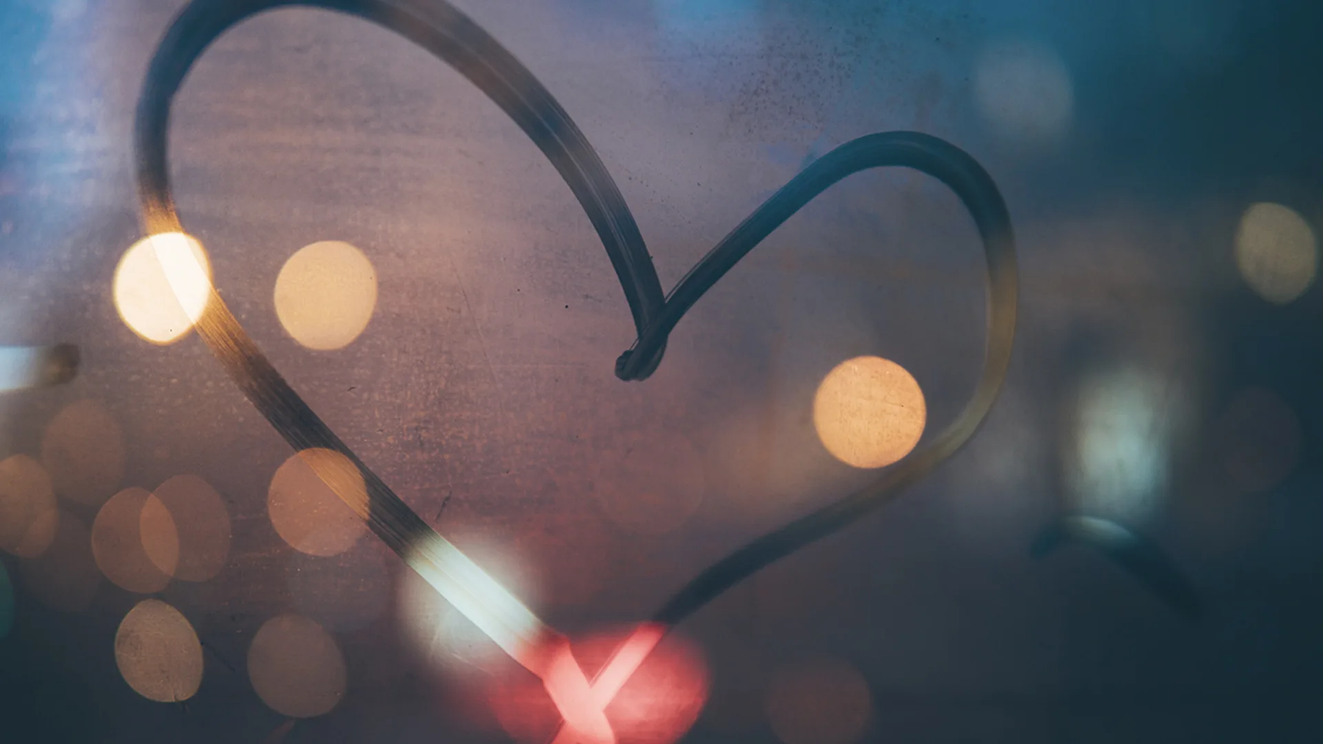A love heart drawn on a window with condensation
