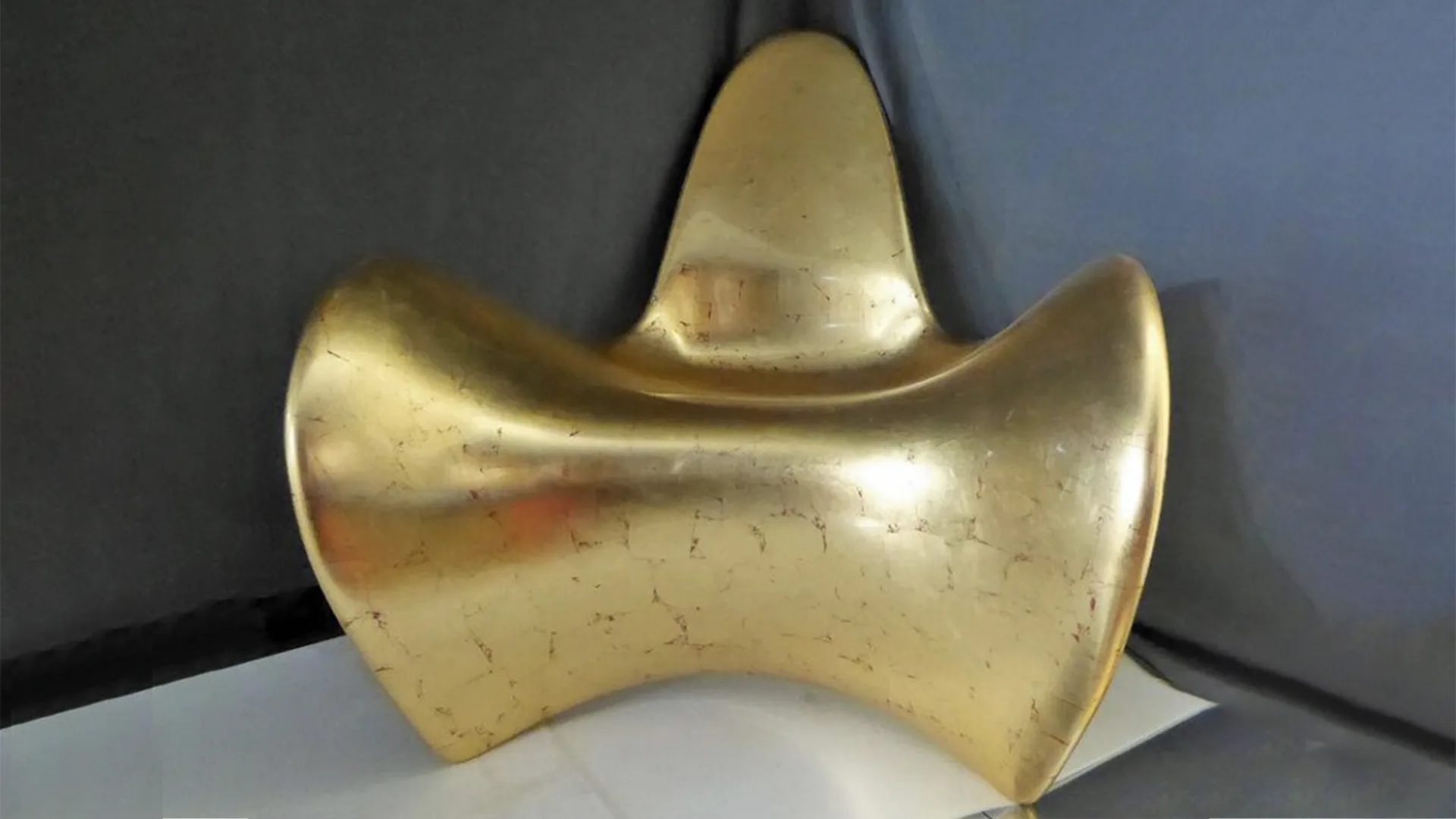 Moulded fibreglass chair covered with gold leaf 