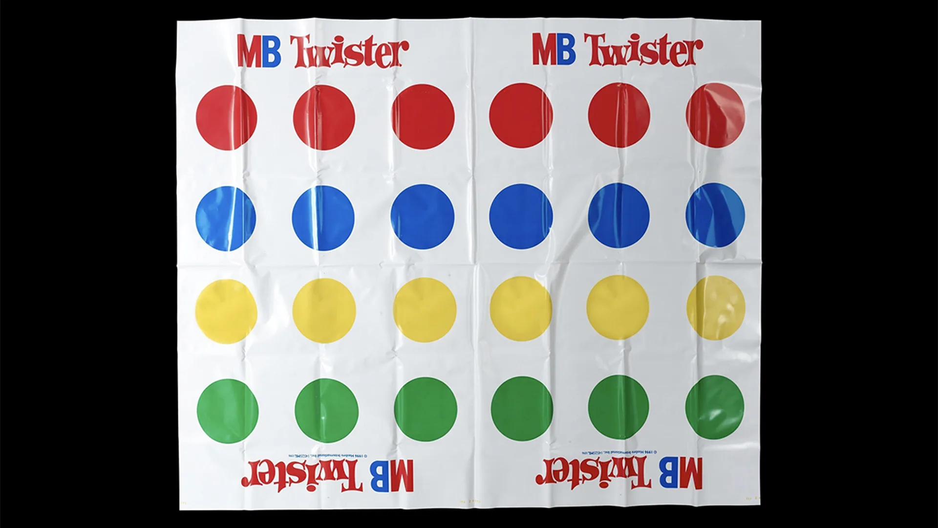 A picture of the Twister sheet with a row of 6 red, 6 blue, 6 yellow and 6 green circles