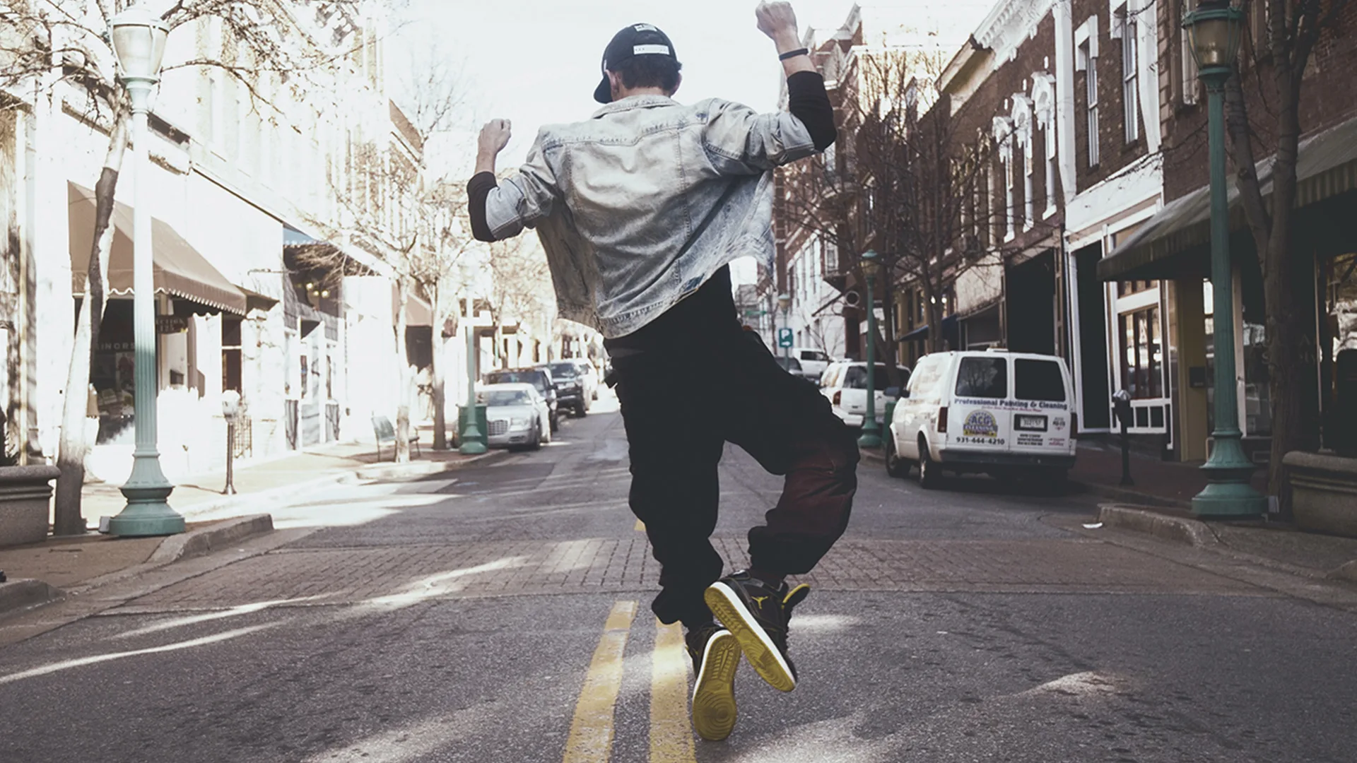 A man dancing in the middle of the road