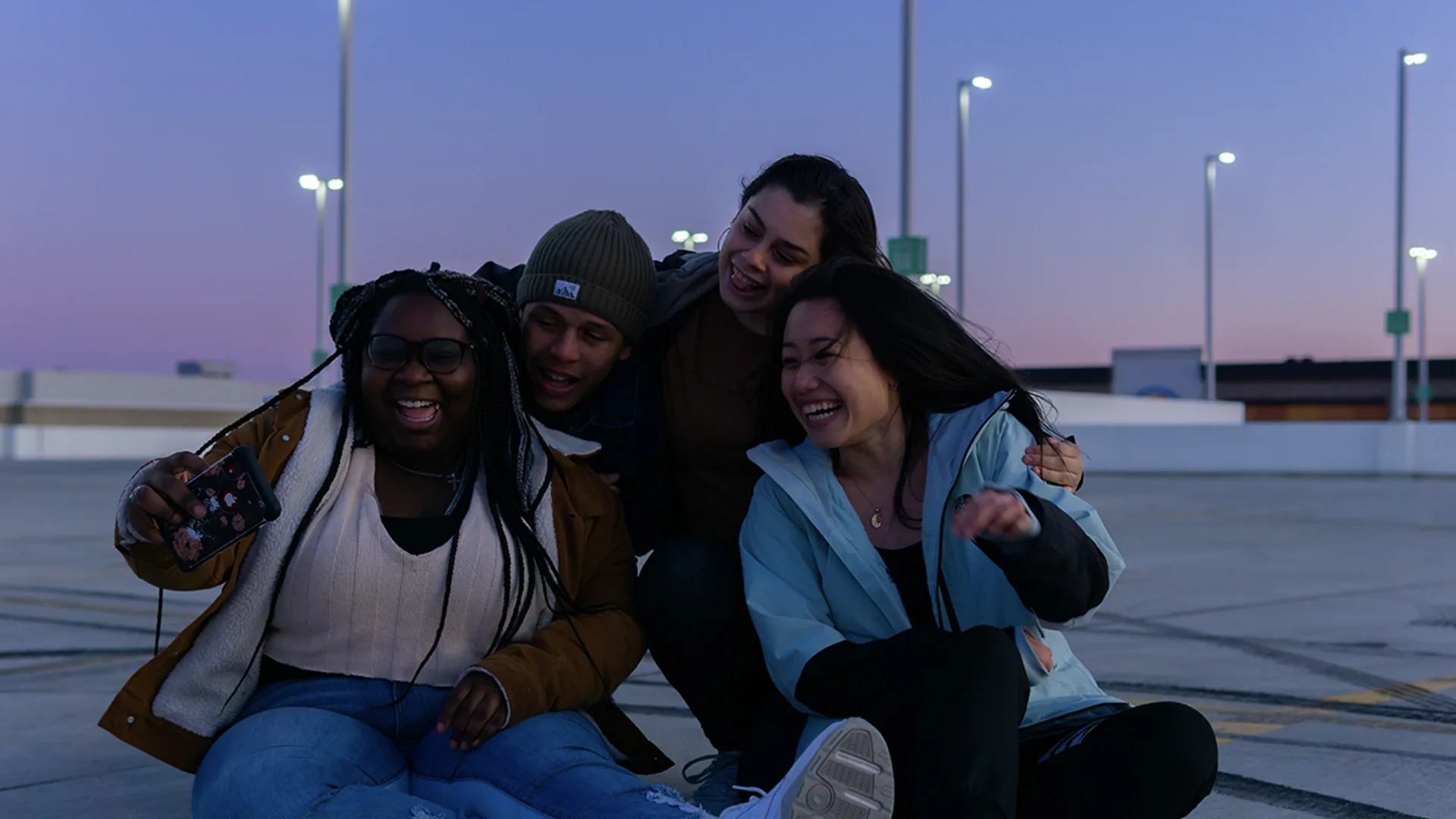 Group of friends laughing and hugging