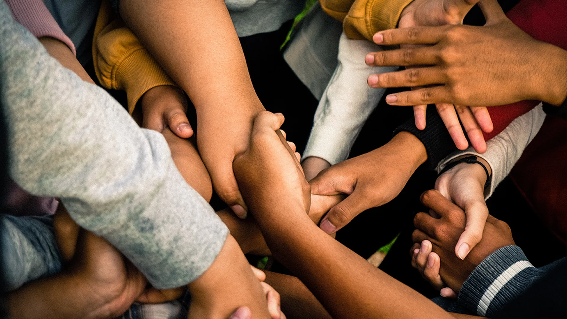 Many people holding hands