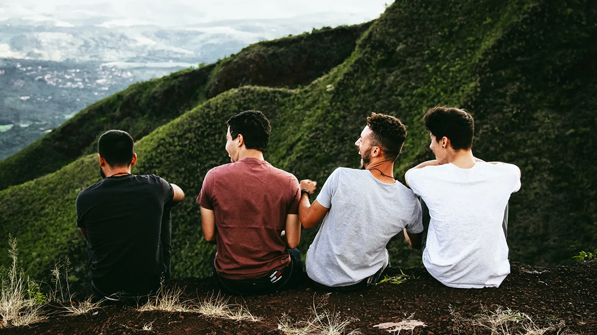 A group of friends with mountains in front of them
