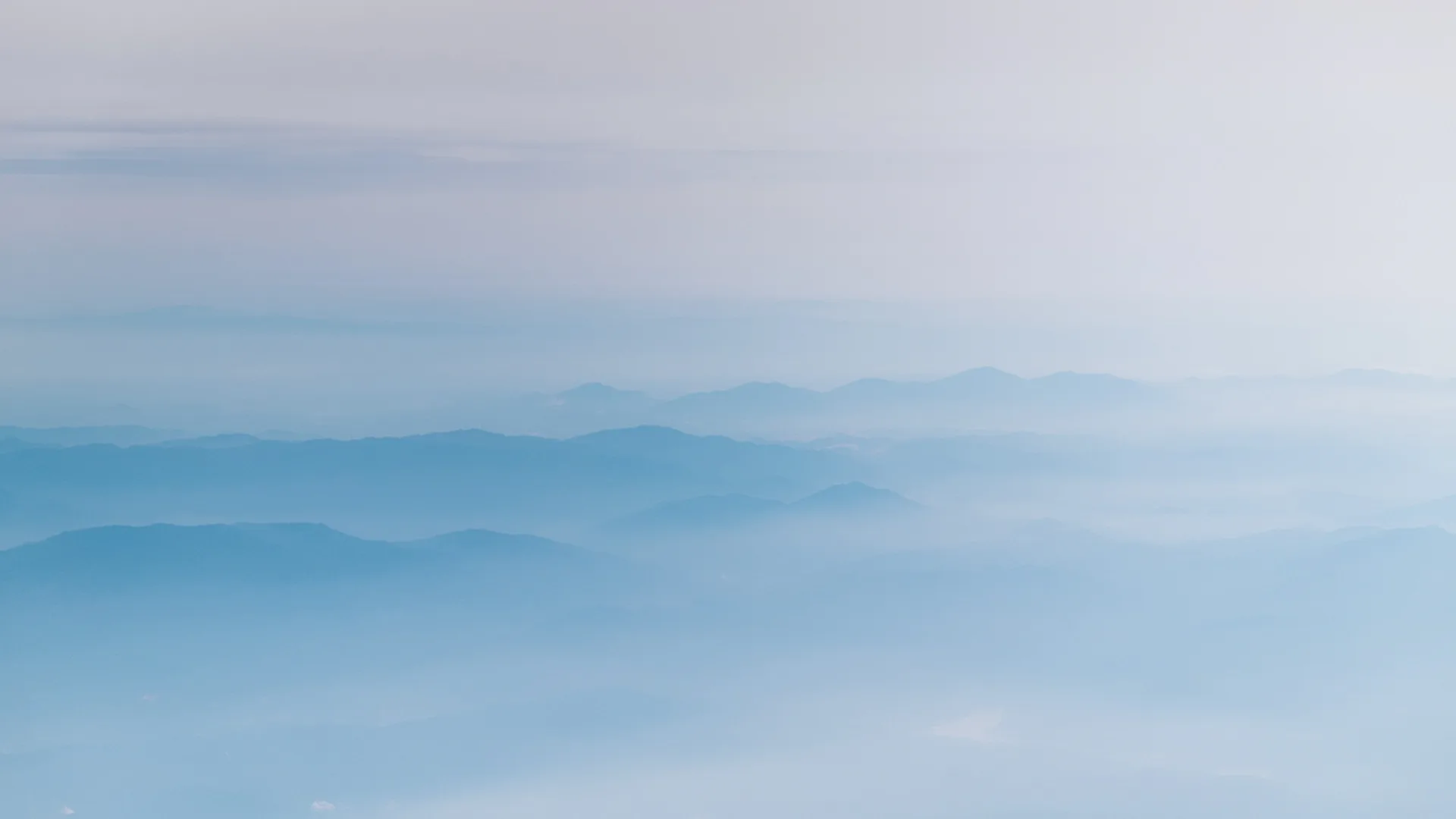 Blue sky with mountains in the background