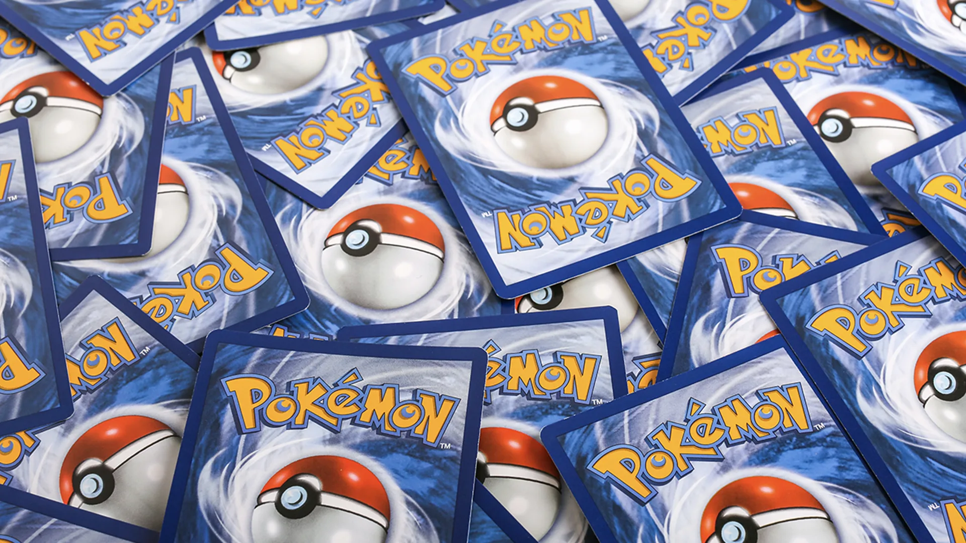 A pile of pokemon trading cards sitting on top of each other
