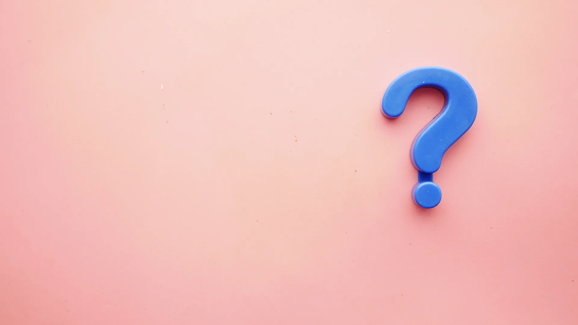 Pink background with a blue question mark