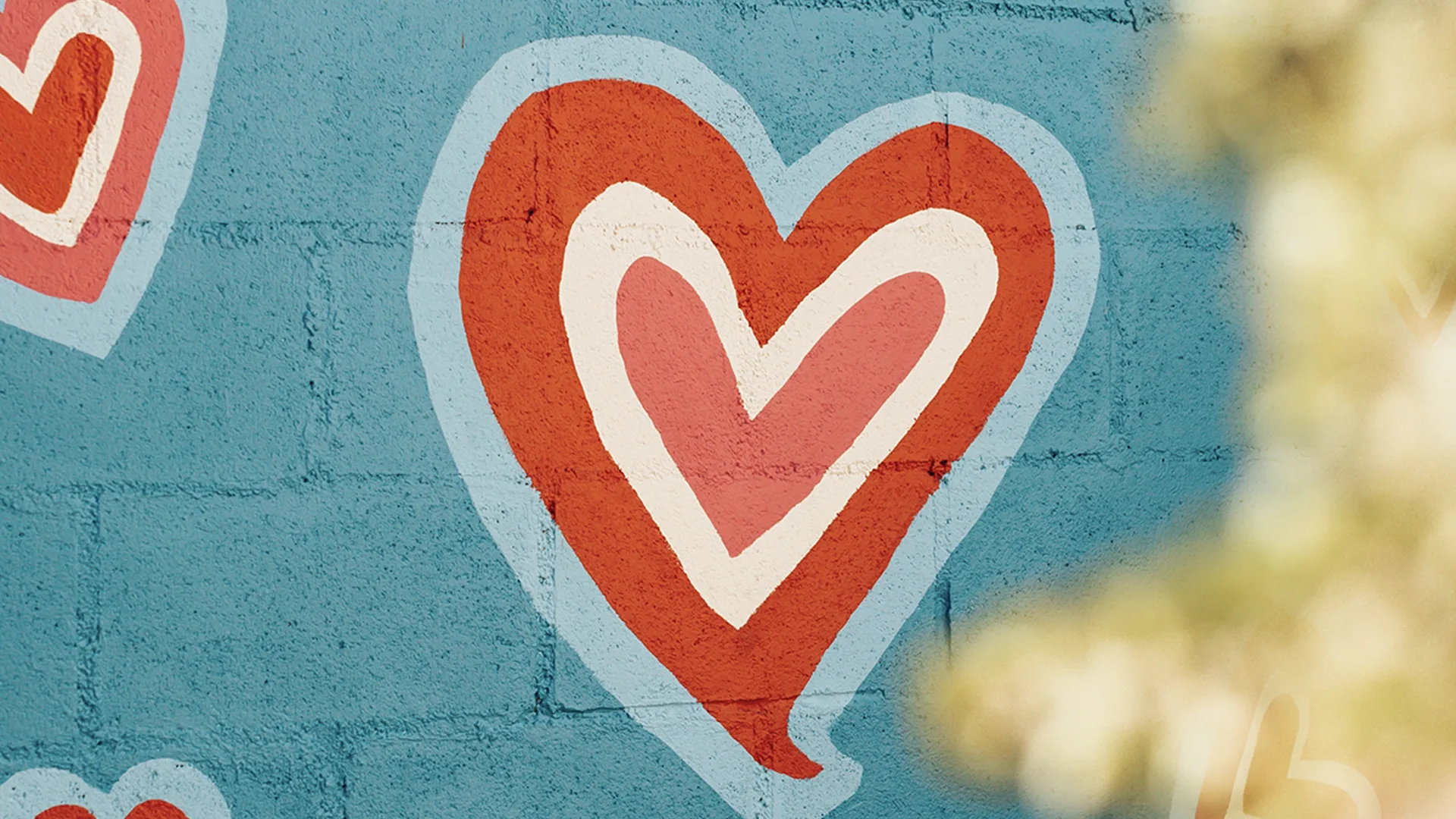 A blue wall with red love hearts on it