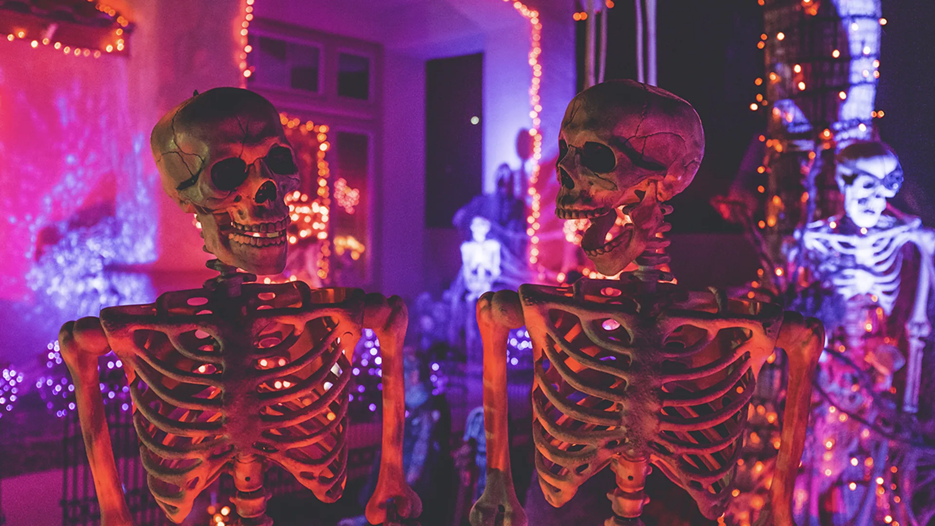 Two fake skeletons at a party