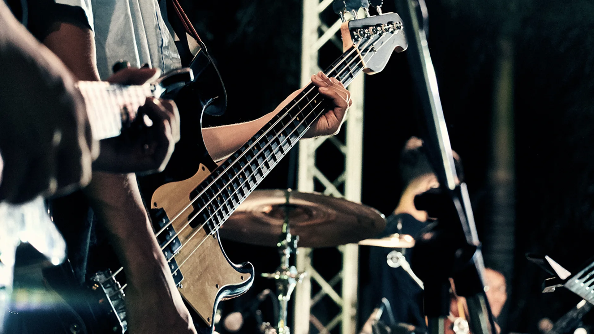 Someone playing a base guitar