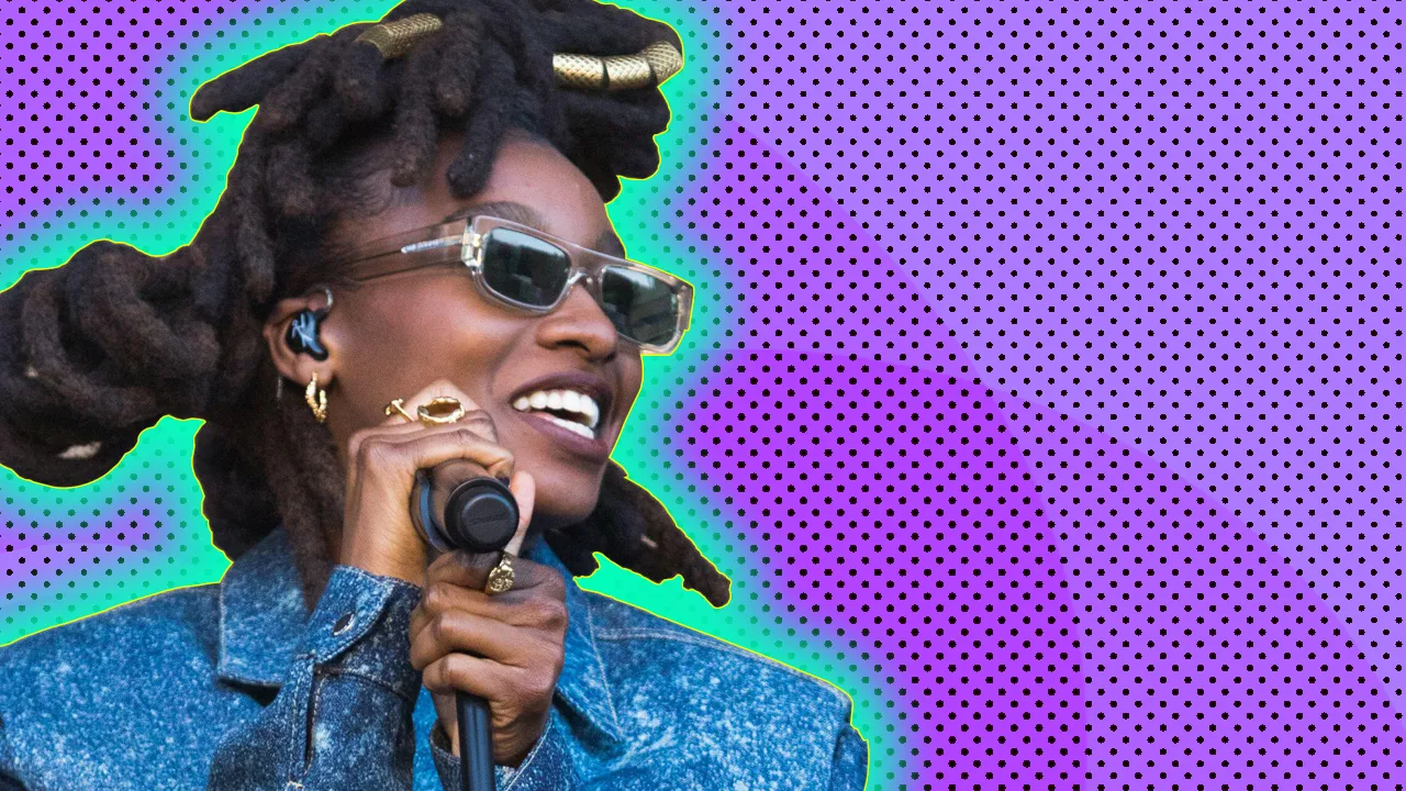 Little Simz performing with a blue glow on a purple background