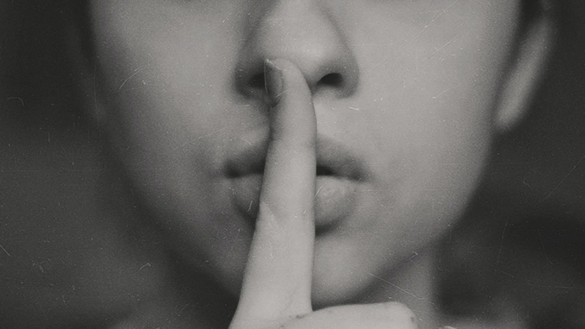 Someone putting their finger to their mouth