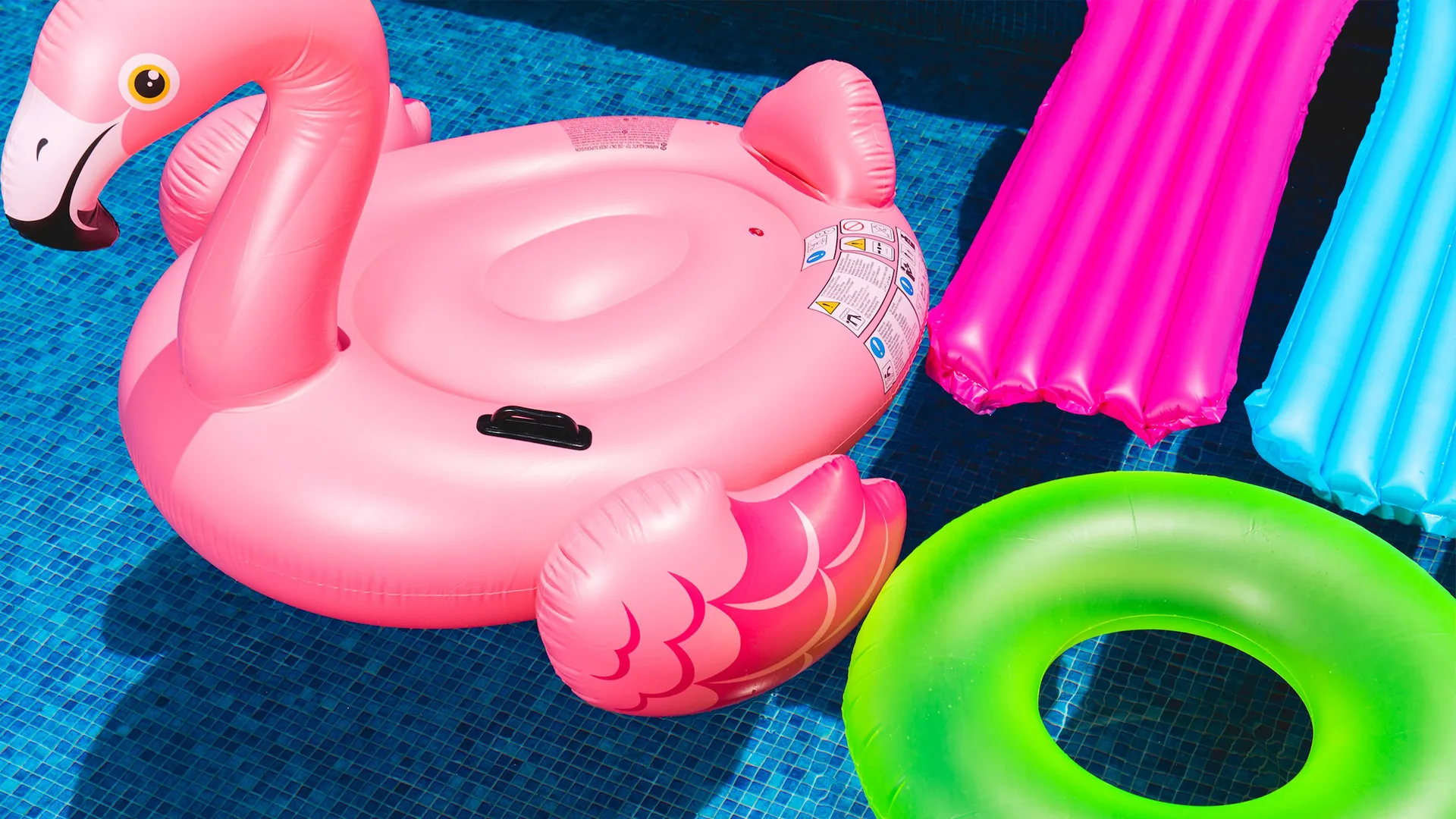 Colourful inflatables floating in blue pool