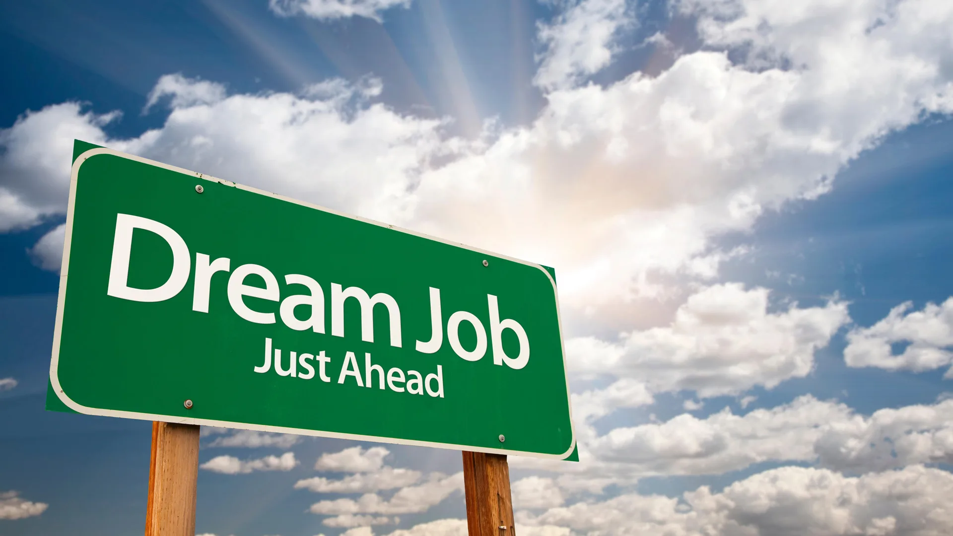 A photograph of a green sign that says "dream