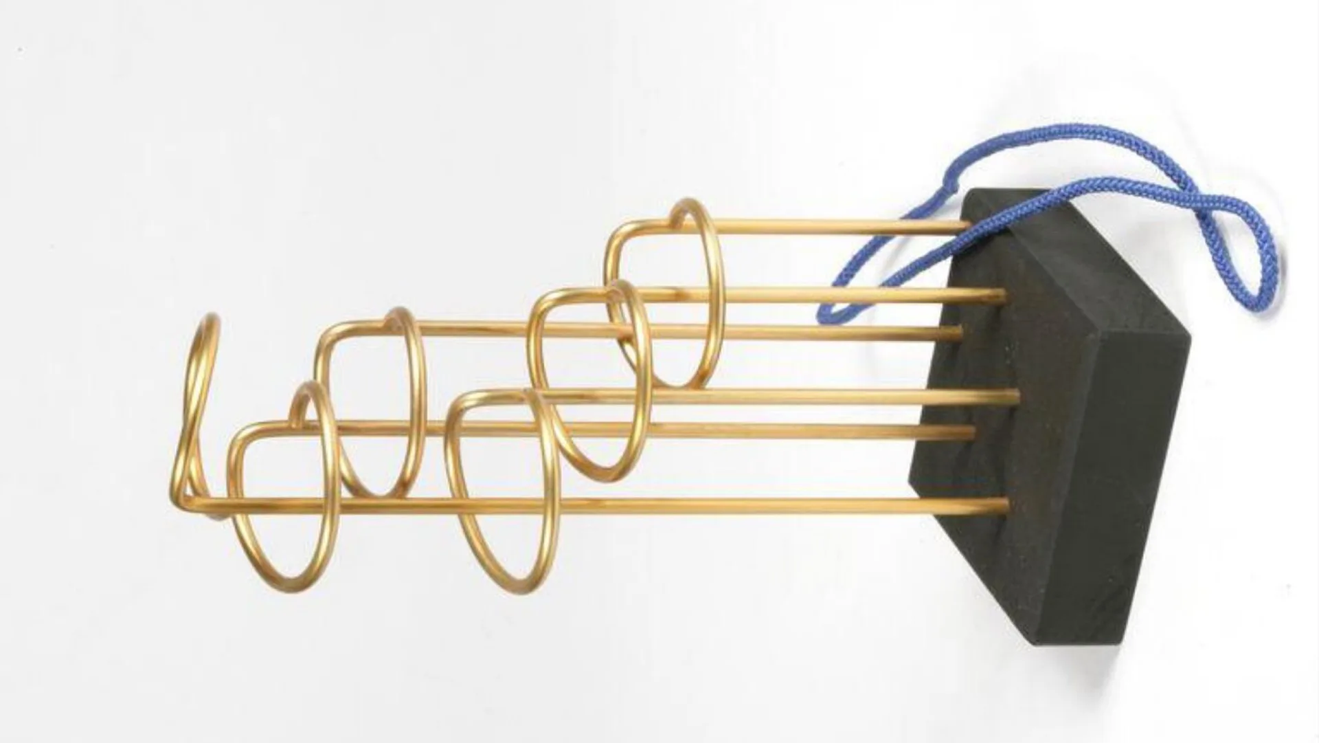 A photo of a toy called 'The Devil's Halo' showing a black box with 6 gold sticks of varying length sticking out with loops on the end and a blue cord against a white background