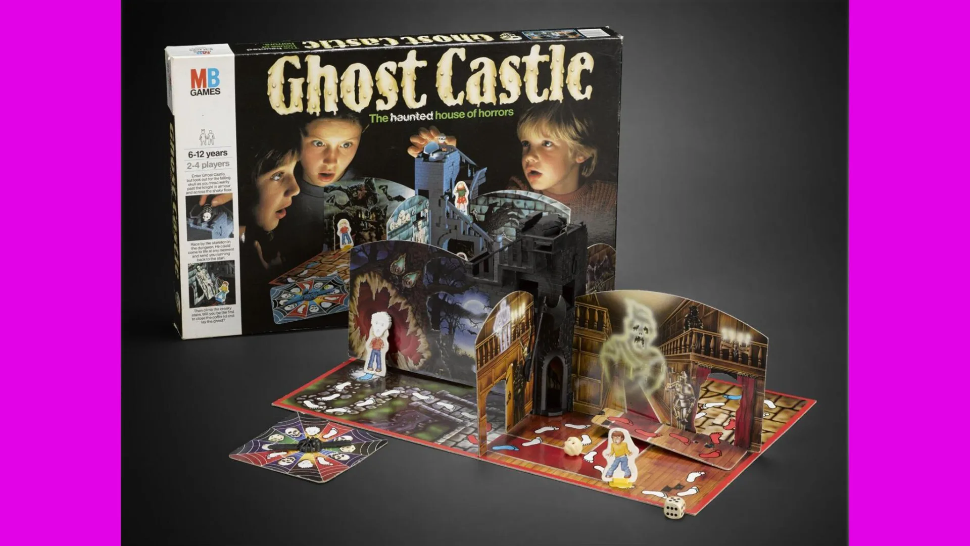 A photo of the 1985 board game Ghost Castle showing the board game box and game itself against a black ground with pink borders
