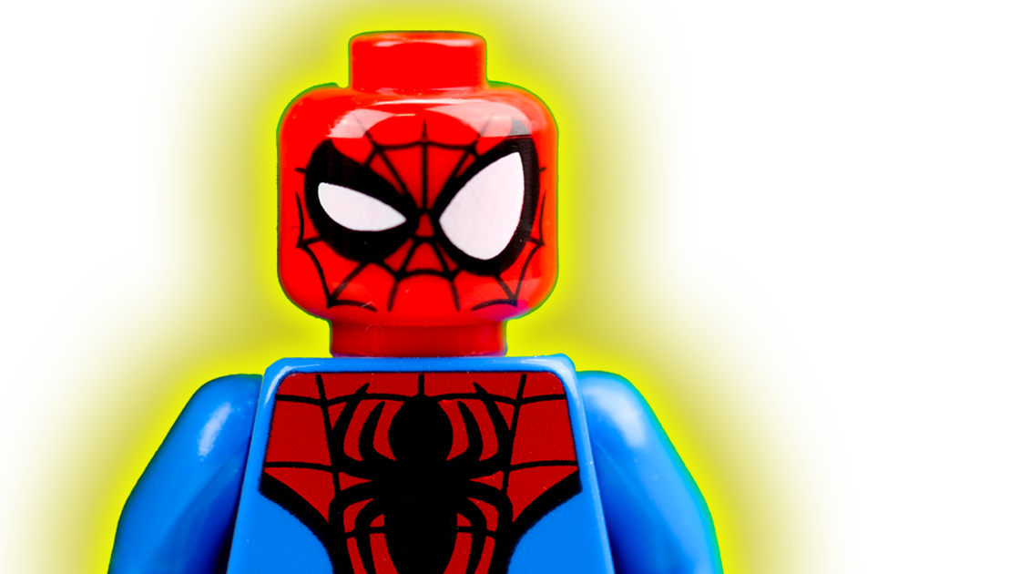 A photo of a LEGO spiderman with a suspicious expression surrounded by a yellow halo.