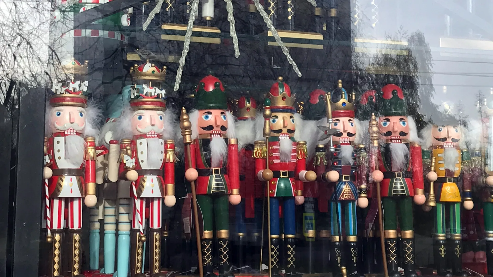 A scene of nutcracker dolls all stood in a line wearing red outfits.